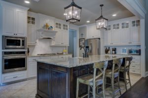 Modern kitchen with polished granite countertops and natural wood cabinets, showcasing a well-maintained space with professionally cleaned natural stone surfaces.