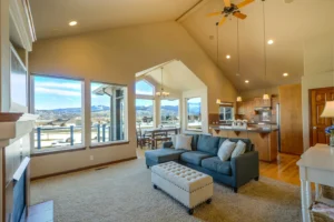 A very clean living room overlooking a mountain town landscape scene. The living room is illustrating tips for spring cleaning in Breckenridge, CO for Exclusive Cleaning and Restoration, a local carpet cleaning, floor and home restoration company in Summit County, Colorado.