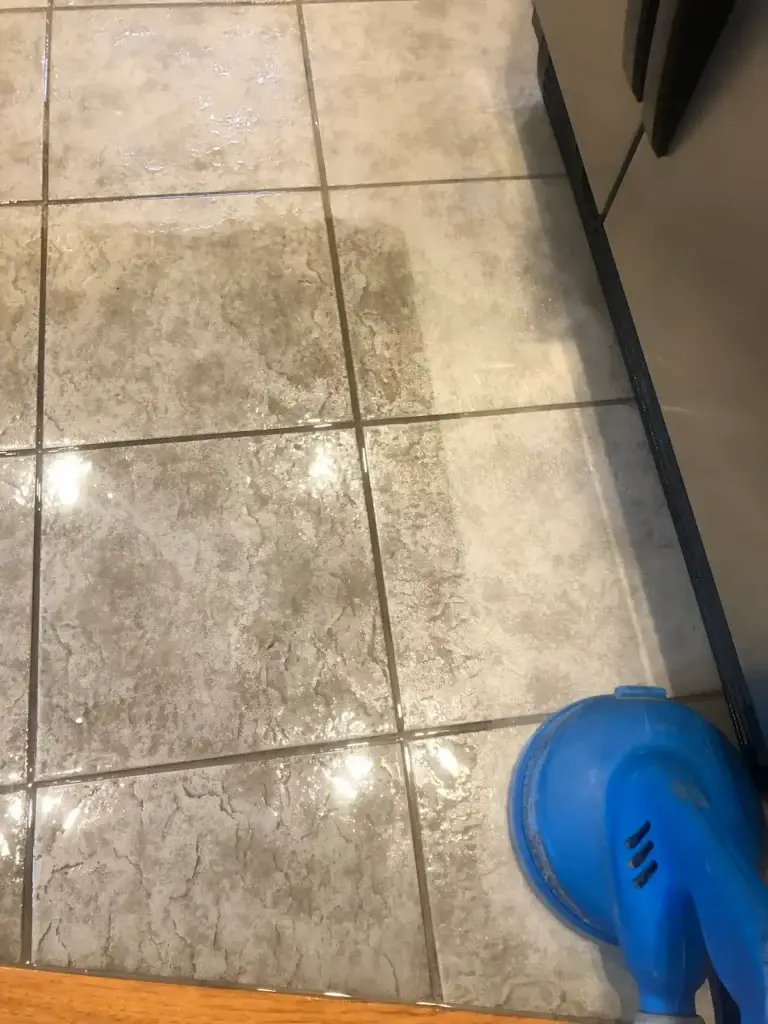 Professional tile and grout cleaning using surface cleaner on kitchen floor in Summit County Colorado