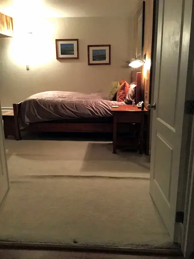 Carpet ripples and buckling in bedroom requiring professional carpet stretching in Summit County Colorado