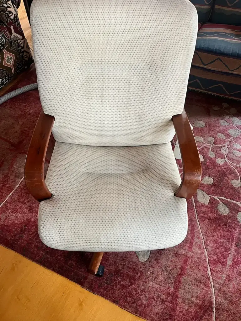An office chair restored to an off-white color after a professional upholstery cleaning in Frisco, Colorado.