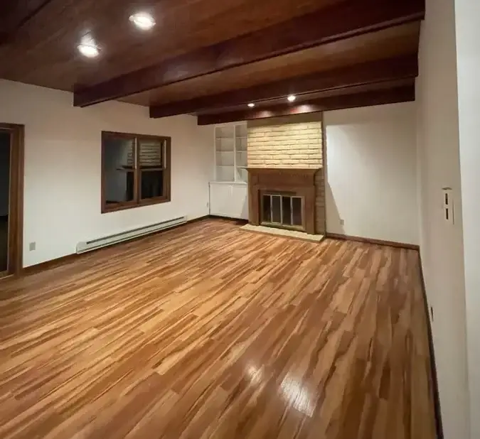 an empty room with professionally cleaned hardwood floors in a summit county condo