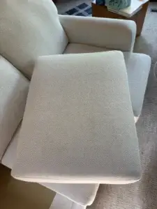 The same light gray herringbone sofa cushion after professional upholstery cleaning by Exclusive Cleaning and Restoration, restored to a fresh, even color.
