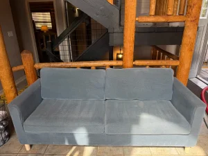 Freshly cleaned blue fabric sofa after professional upholstery cleaning in a Summit County mountain home vacation rental